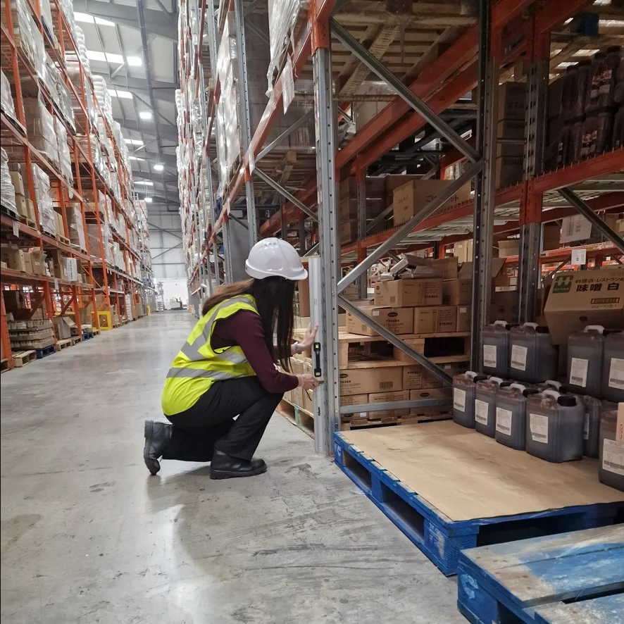 An inspector checking the racking for signs of damage
