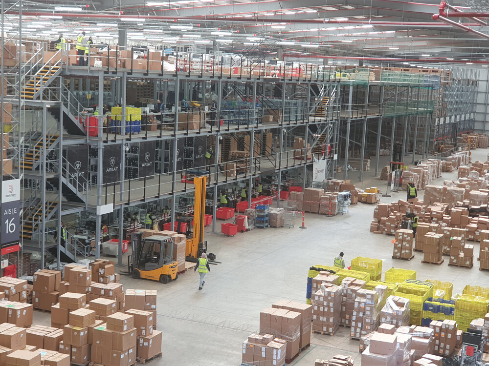 racking regulations blog - raxel a busy warehouse with a multi-tier racking structure